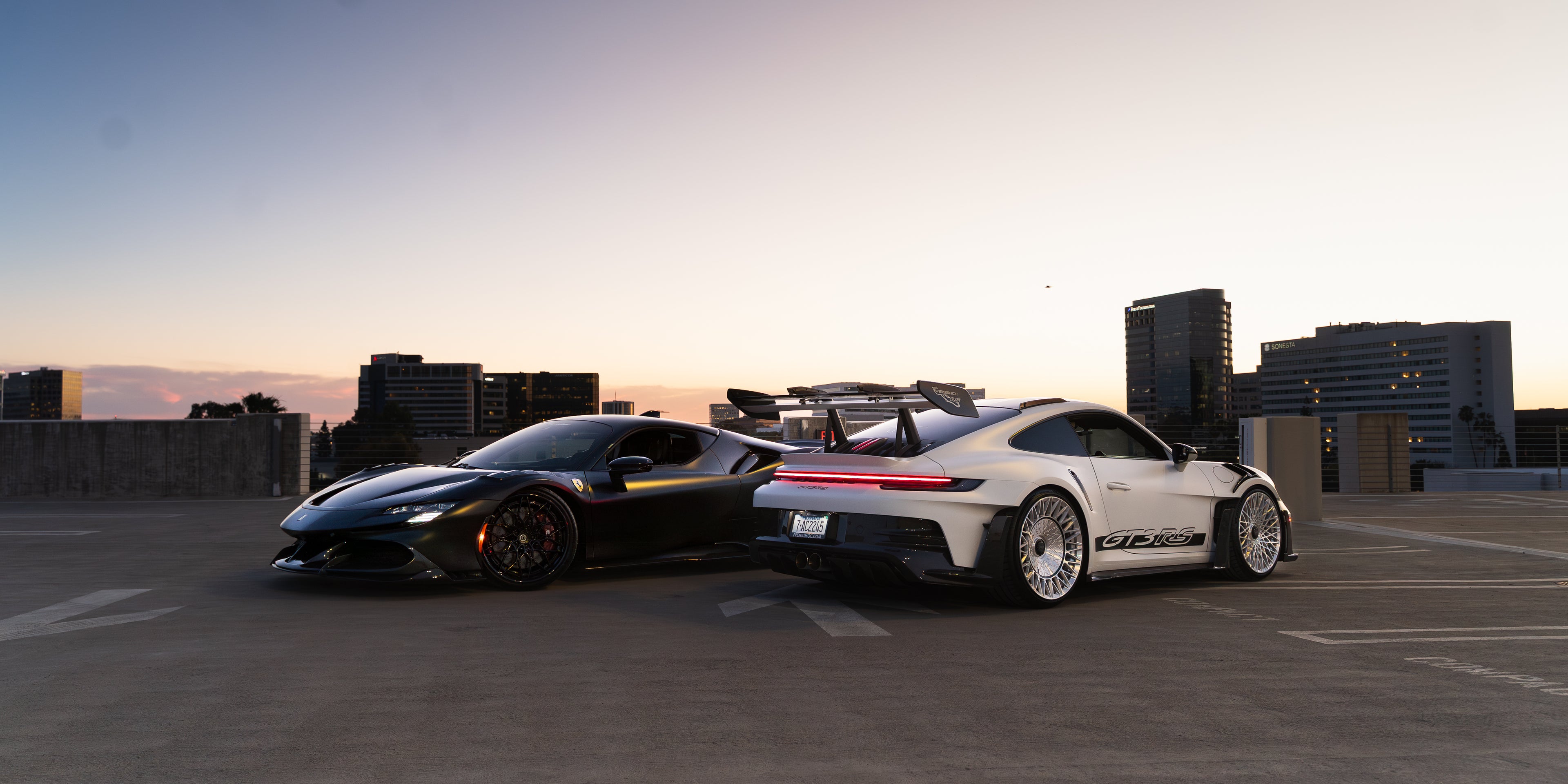Ferrari SF90 in VOIR atelier black matte paint protection film next to Porsche GT3 RS in VOIR spectre satin paint protection film